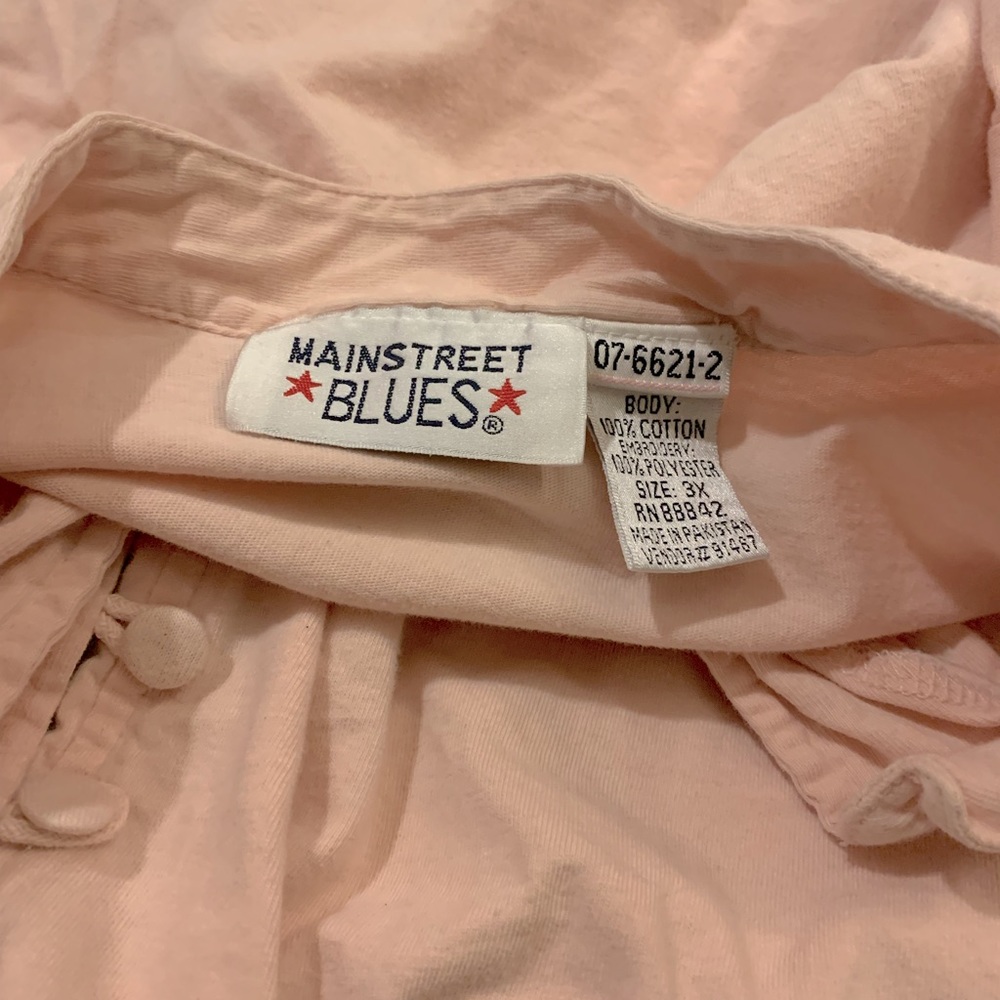 Light pink/cream color button down blouse has been warn only a couple times!